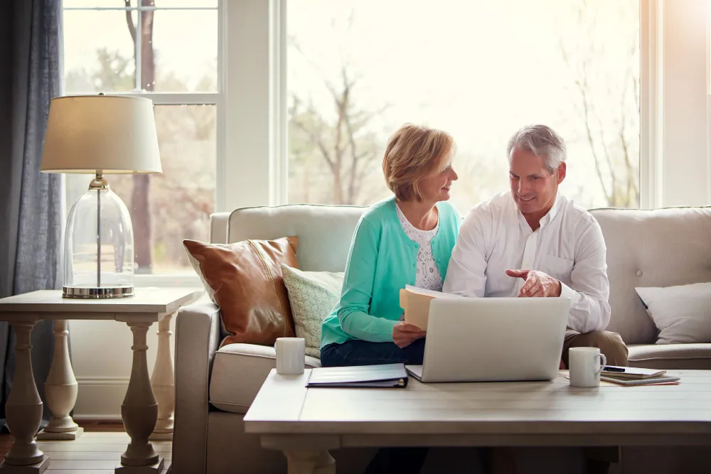 Couple Sat on a Sofa with a Laptop