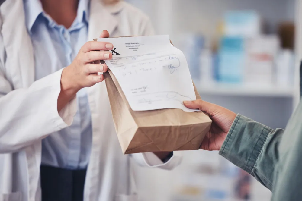 Pharmacist holding a prescription bag